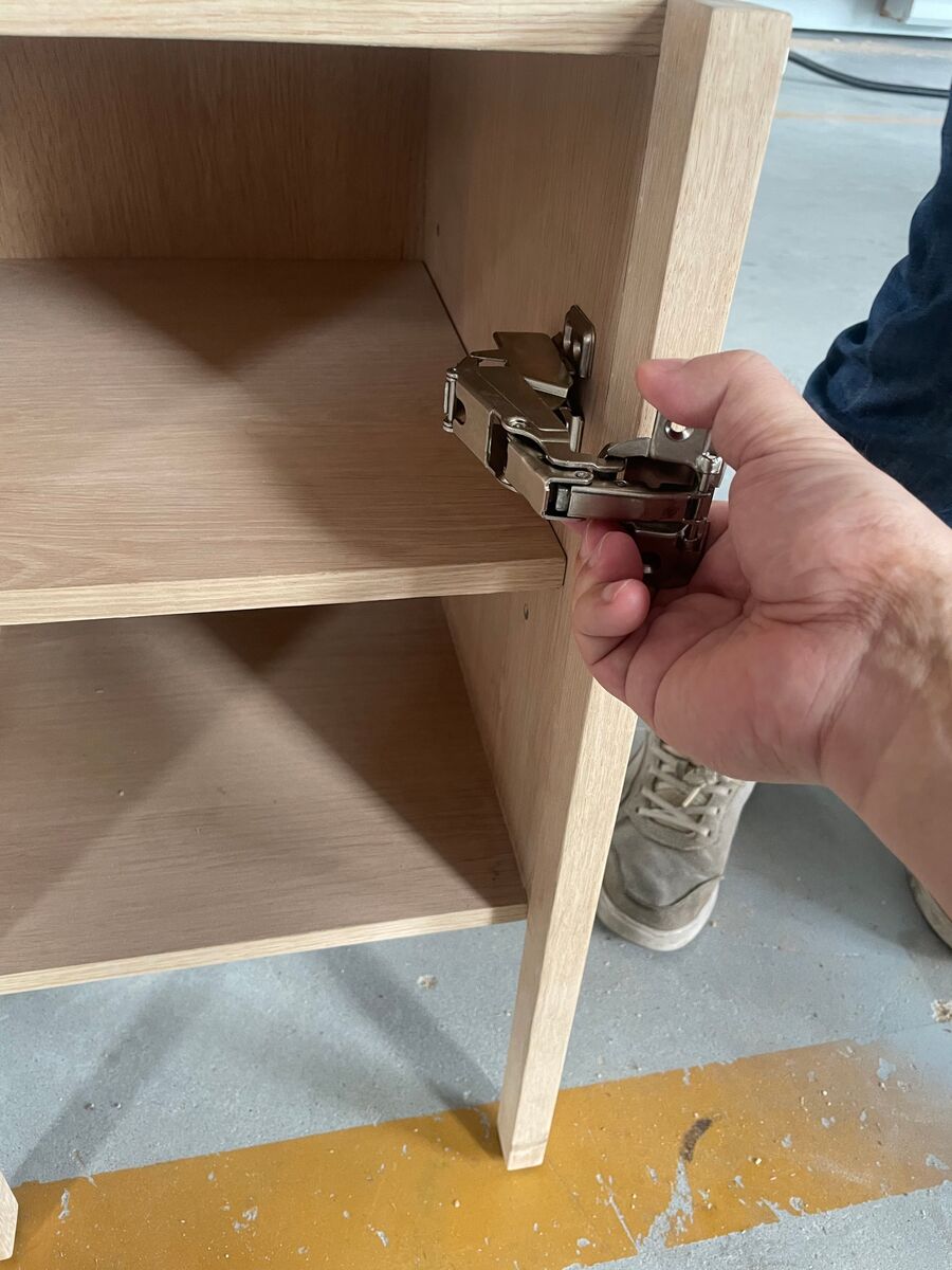 Testing an alternative hinge on the cabinet door